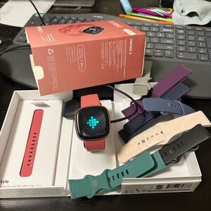 fitbit Versa 4 Smartwatch with Coral Band and Multiple Interchangeable Straps